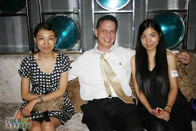 two Chinese women and a Western man sitting