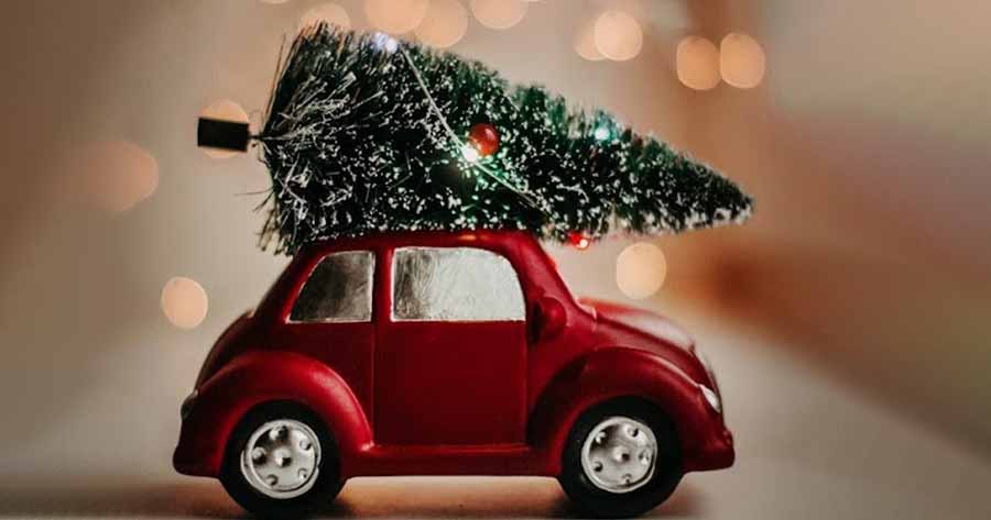 Christmas tree atop a red car.