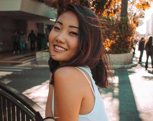 Woman in a white tank top.